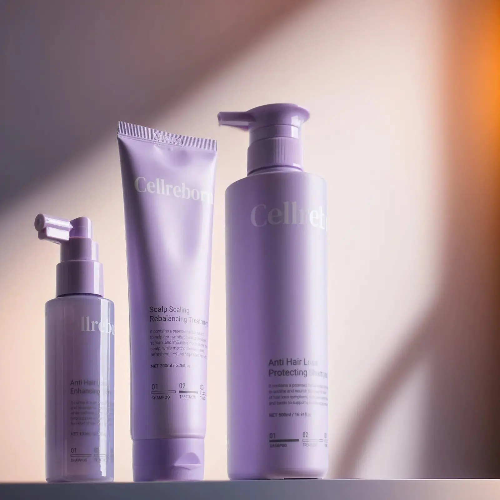 CELLREBORN lavender scalp care packaging (shampoo, treatment and tonic) styled in soft light