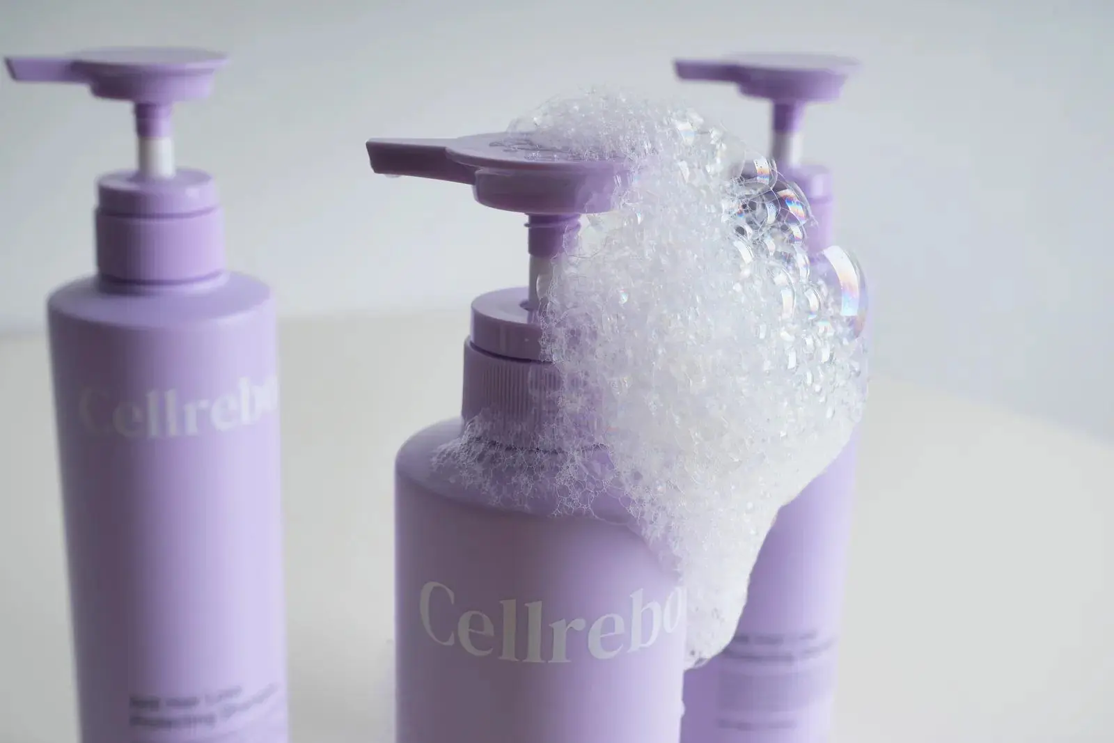 CELLREBORN lavender scalp care packaging (shampoo, treatment and tonic) styled in soft light