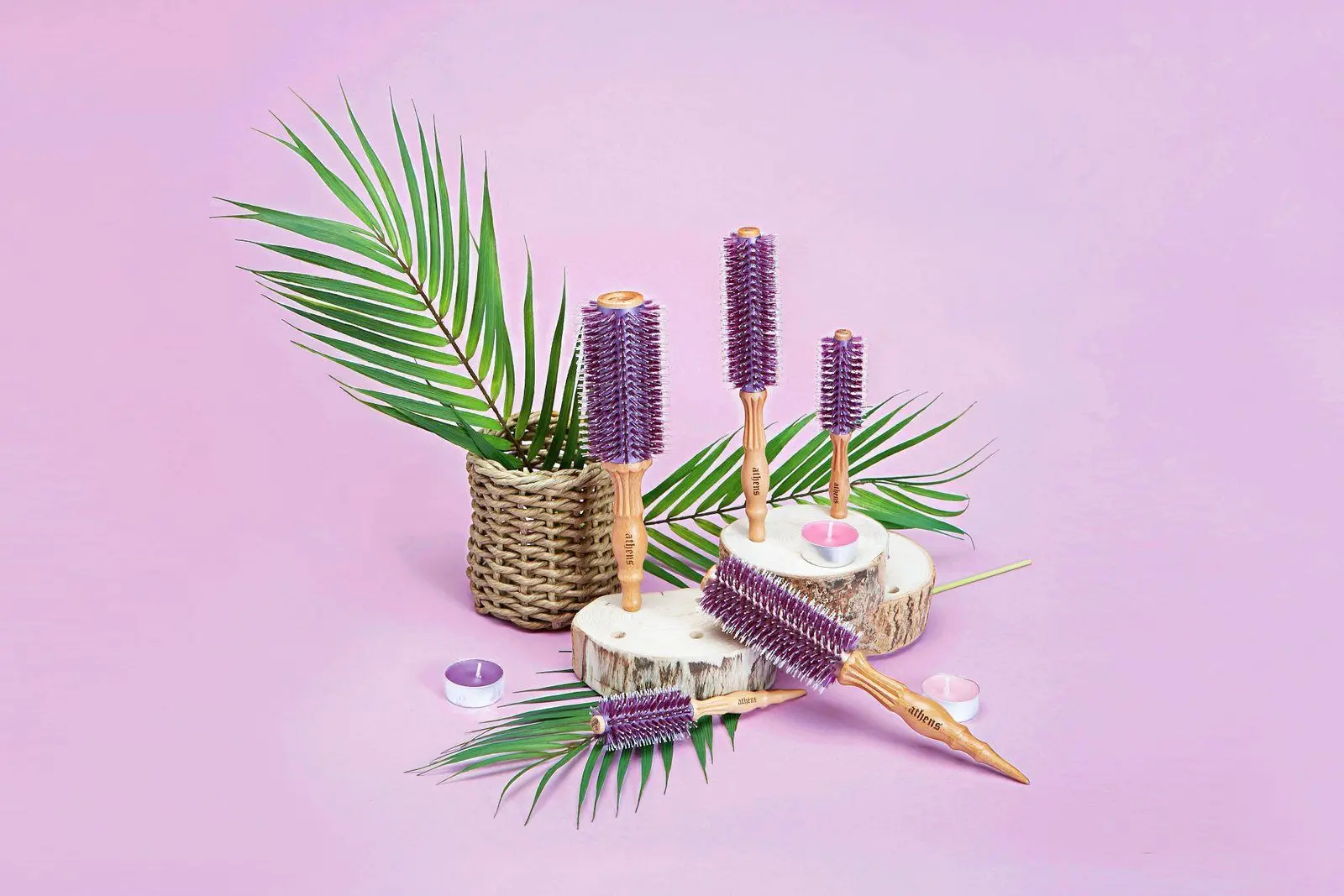 Athens Goddess Roll Brushes arranged with palm leaves and a woven basket on a lilac surface