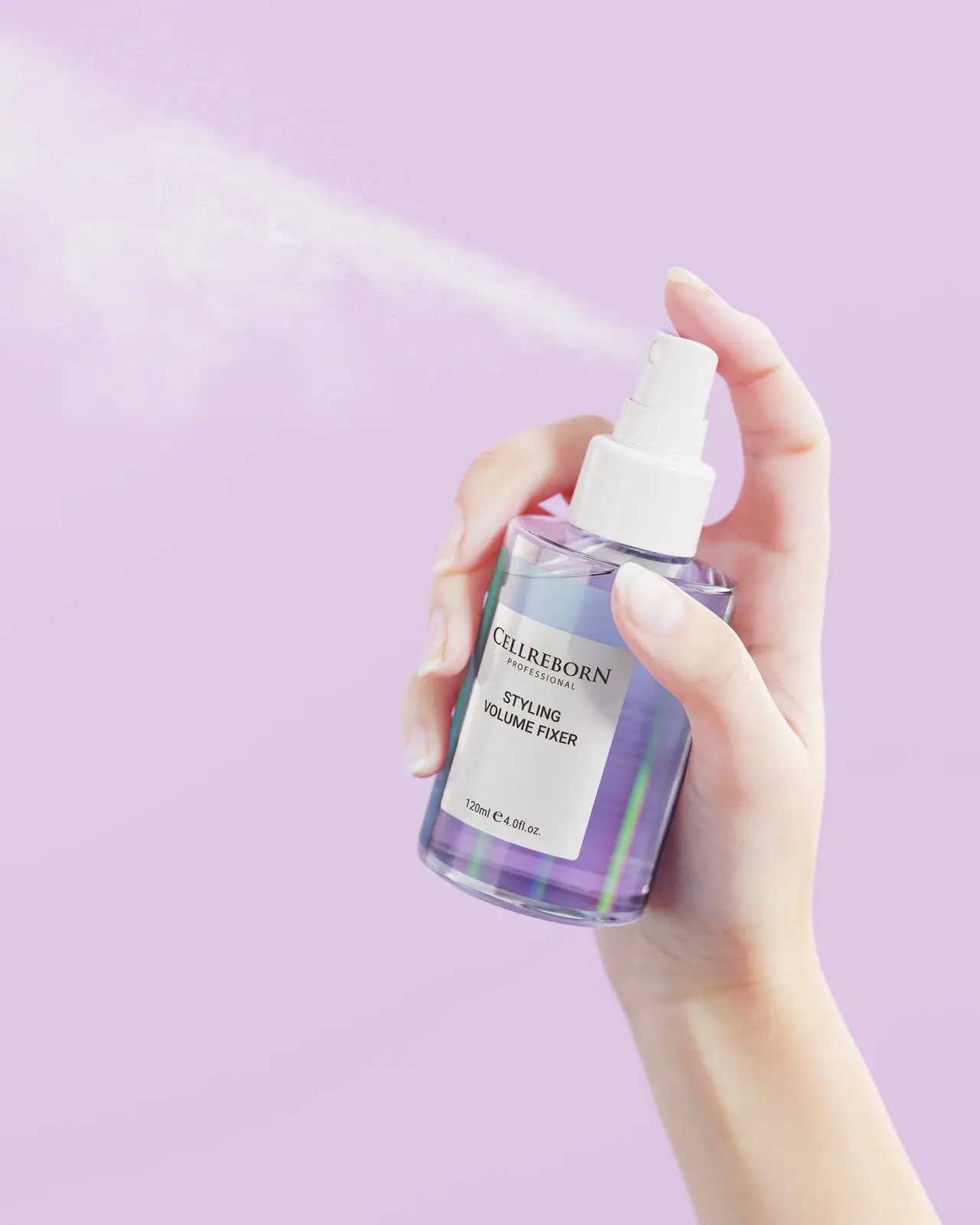 A hand spraying CELLREBORN Athens Styling Volume Fixer, with a fine mist against a lilac backdrop