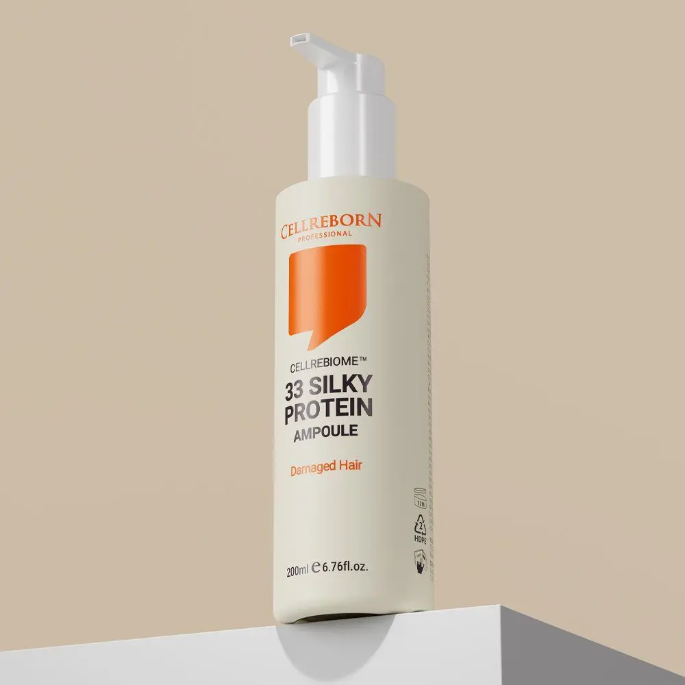 Cellrebiome 33 Silky Protein Ampoule bottle on a white block against a beige backdrop