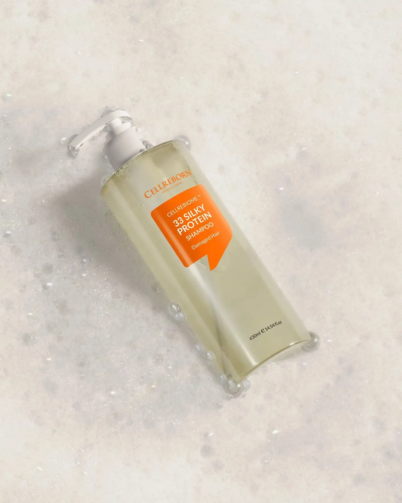 Cellrebiome 33 Silky Protein Shampoo bottle lying diagonally on white foam, seen from above