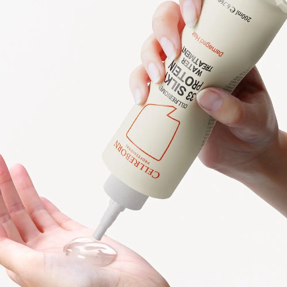 Hands squeezing Cellrebiome 33 Silky Protein Water Treatment into a palm