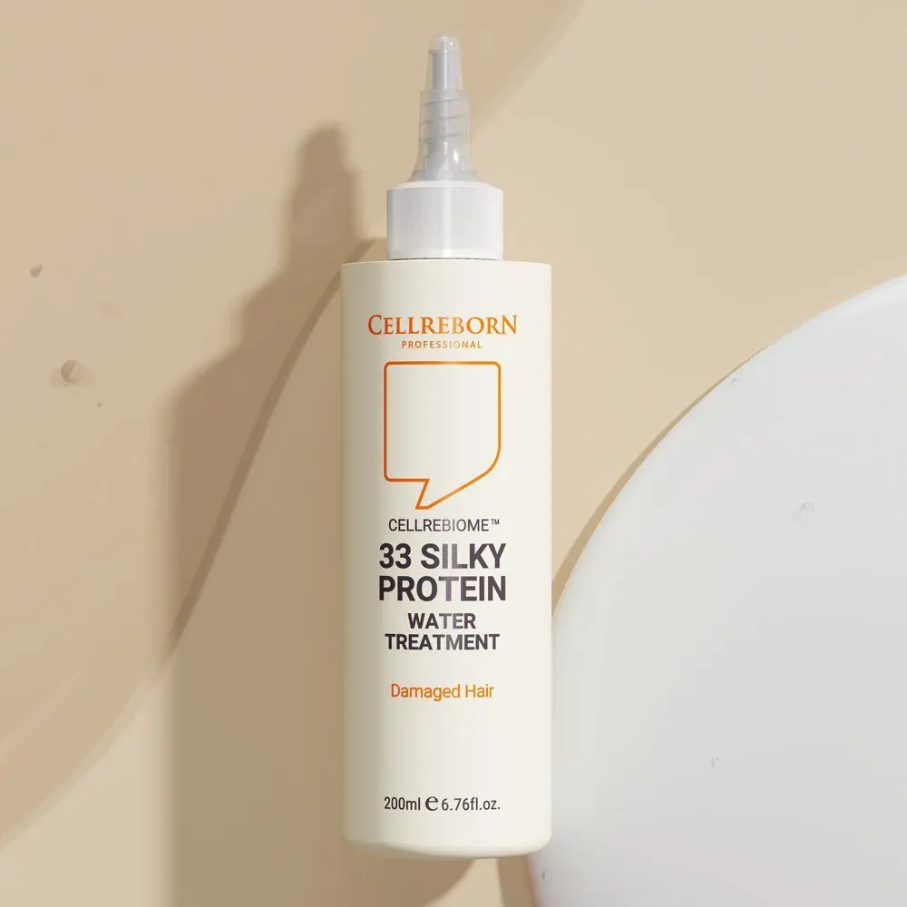 Cellrebiome 33 Silky Protein Water Treatment bottle against a beige backdrop with soft shadows
