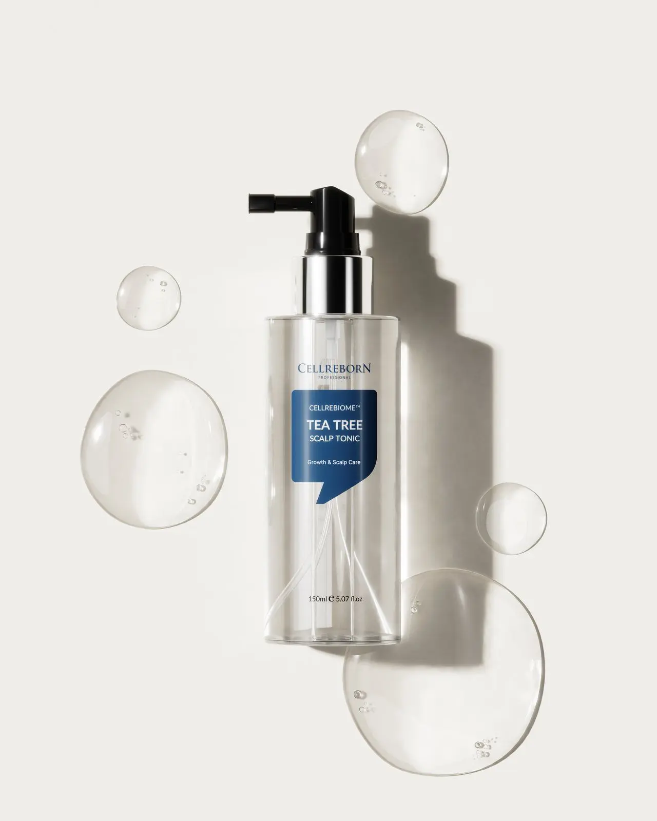 Cellrebiome Tea Tree Scalp Tonic bottle with clear gel bubbles on a white surface, seen from above